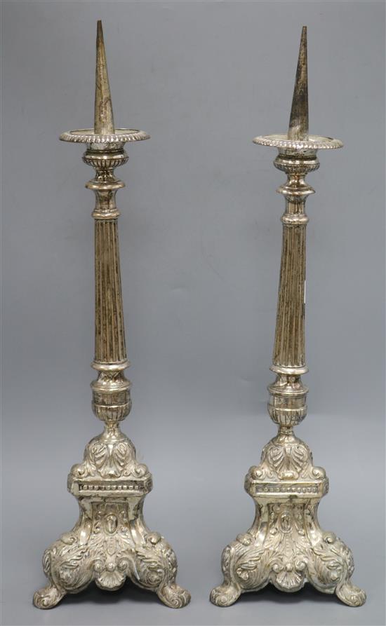 A pair of silver plated on brass pricket candlesticks height 55cm